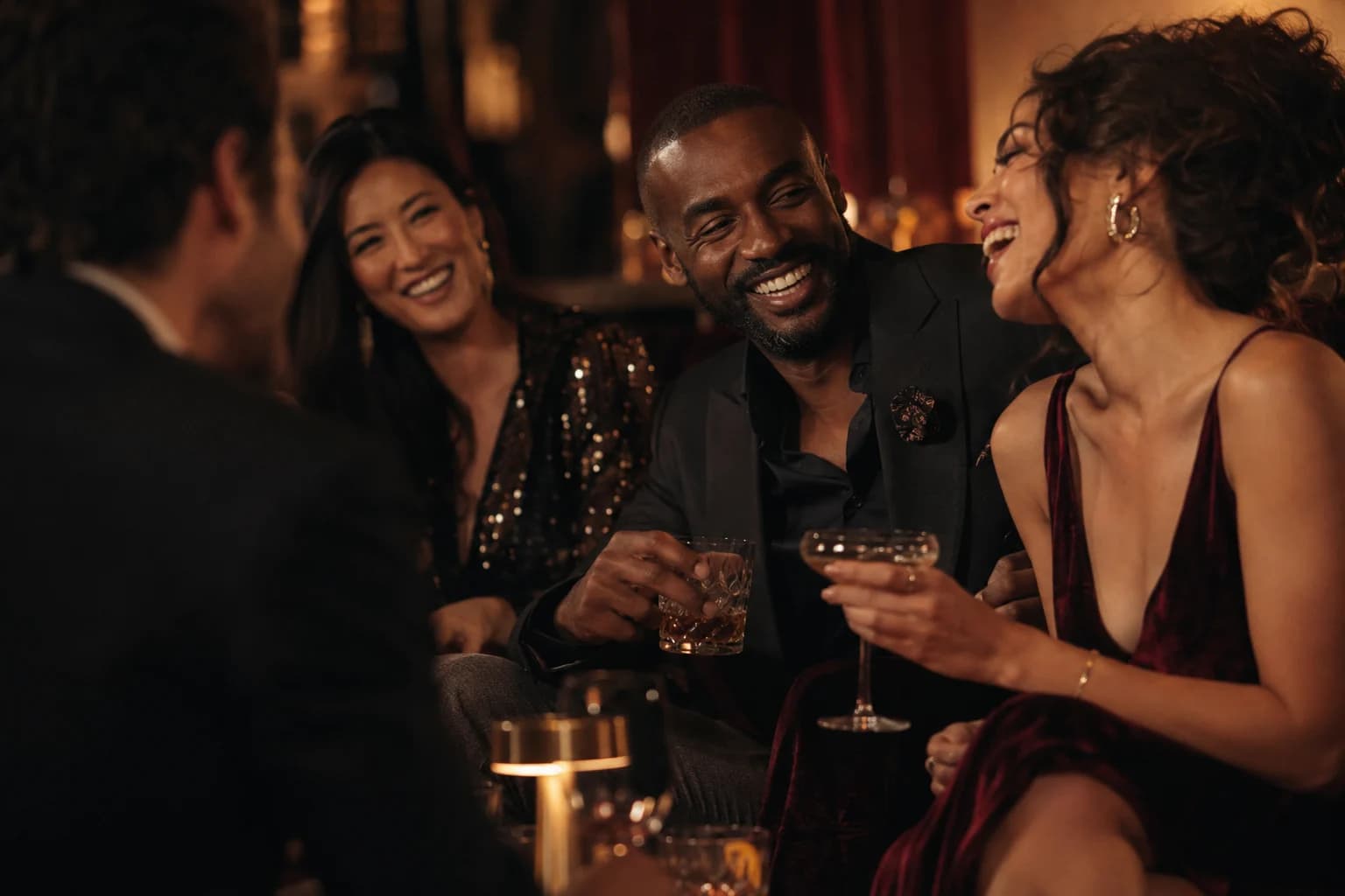 Guests sharing a spontaneous laugh over drinks